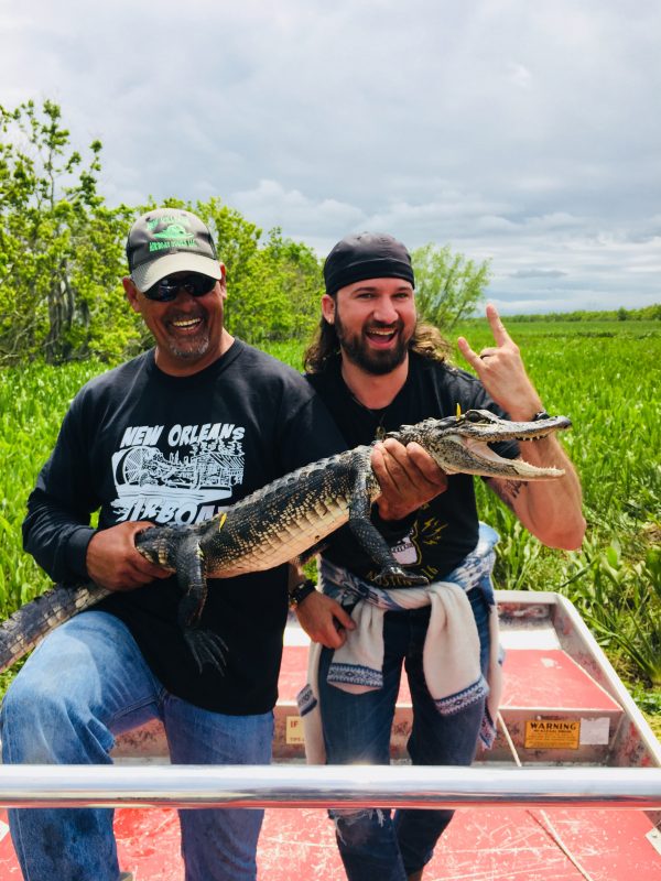 posing with a baby gator
