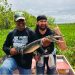 posing with a baby gator